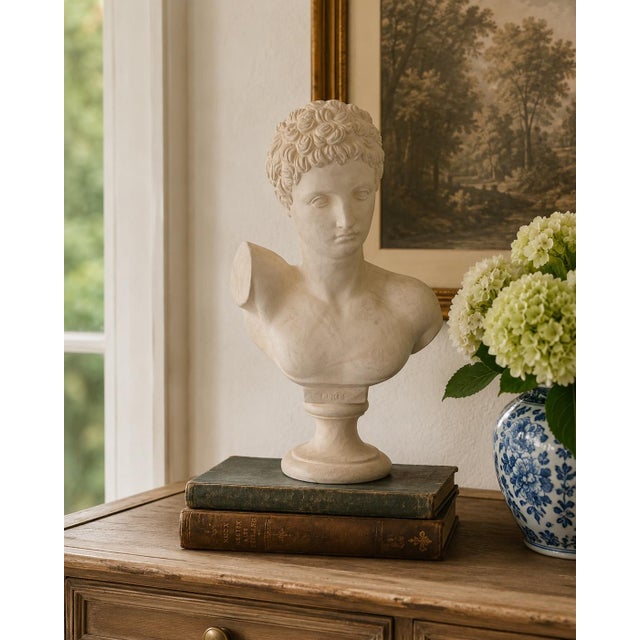 A finely modeled vintage plaster bust depicting Hermes, the classical messenger god, with tightly curled hair, a...