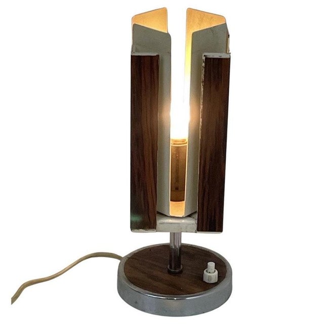 Midcentury modern table lamp made by the Ducth comapny Phillips. Ca. 1950’s. made from a chrome base with wood fineer that...
