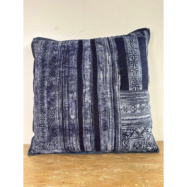 Decorative pillow made from an antique indigo-dyed textile, showcasing bold vertical striping and intricate geometric...