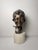 This 19th-century sculpture depicts the face of a Neapolitan street urchin (scugnizzo in dialect), characterized by a...