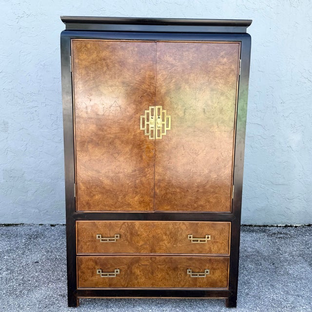 This vintage chinoiserie armoire by Century Furniture pairs luminous burlwood with a sleek black frame for striking East-...