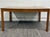 This a gorgeous Mid-Century Modern (MCM) dining table featuring a richly patterned wood-grain laminate top with warm...