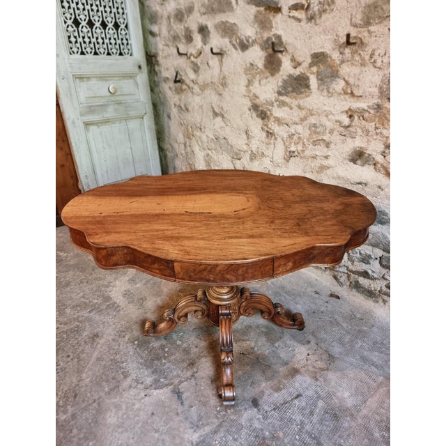 Antique French walnut violin table dating from approximately 1880–1900, featuring a shaped violin-form top and a central...