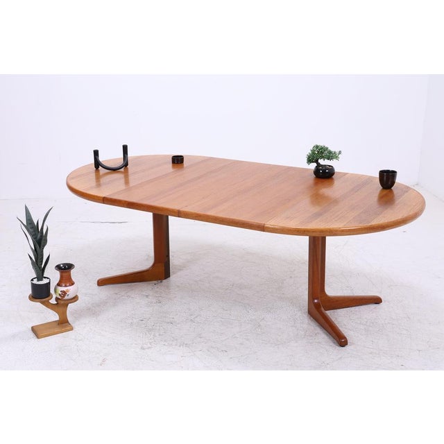 Vintage dining table by CJ Rosengaarden from the 1960s. Its clean lines, warm teak grain, and elegant base make it a...