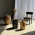 Side table in black petrified wood with beige striations and a semicircular arc, H35 D24. Petrified wood is a fossilized...