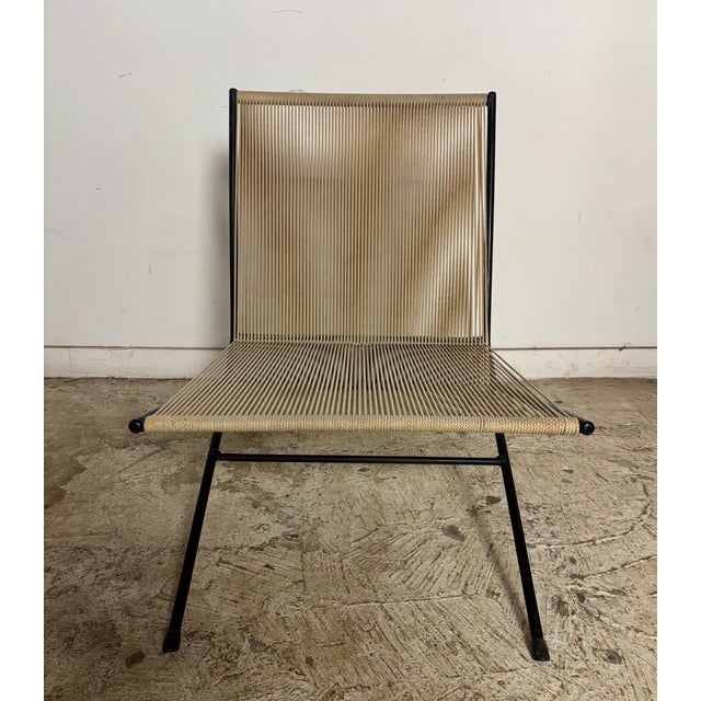 This chair is not marked or stamped with authenticity, but is an original rope lounge chair from the 1950's. It is both...