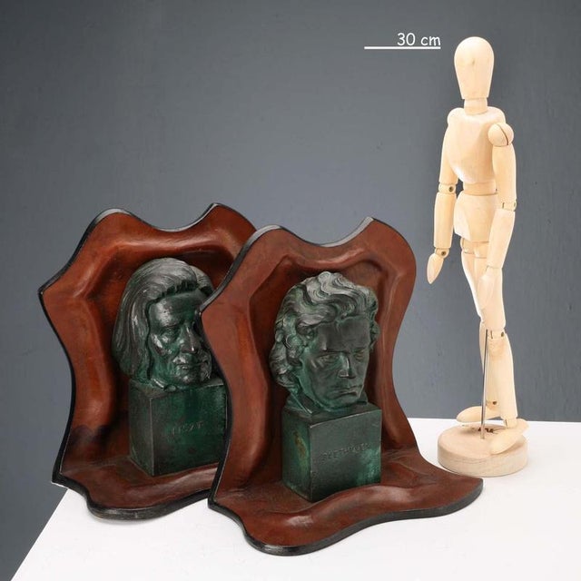 Pair of leather bookends with bronze sculptures depicting the faces of composers Liszt and Beethoven. This piece is...