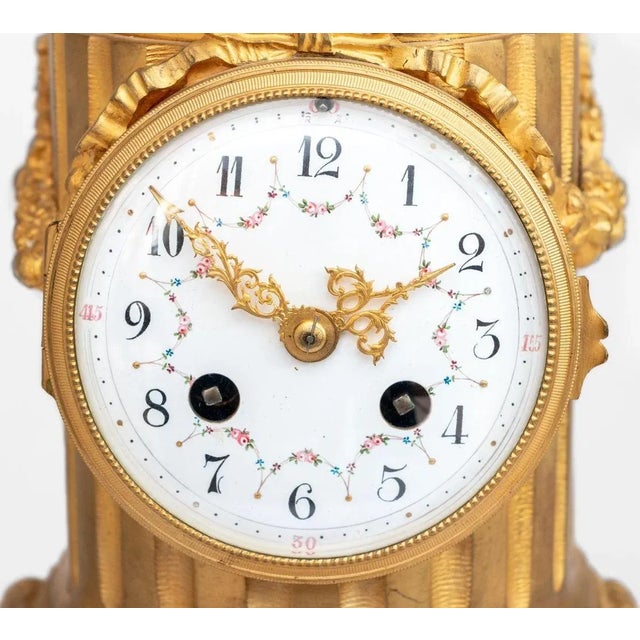 Louis XVI Style Cupid Patinated and Gilt Bronze Clock, late 19th century, the circular enamel painted dial, with strike on...