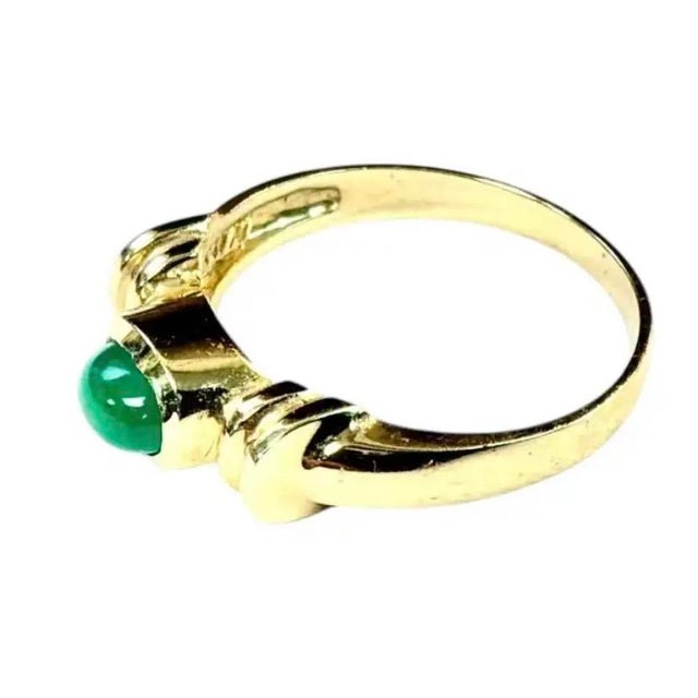 Vintage 14K Gold and Jadeite Cocktail Ring. Ring features a vivid natural green oval jadeite cabochon in a bezel-set...