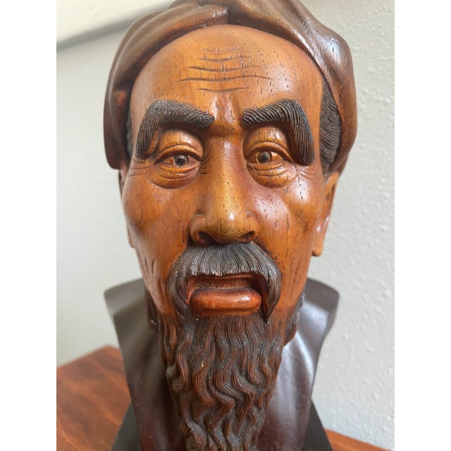An extraordinary hand-carved hardwood bust of Ho Chi Minh, signed Thanh Lê – Vietnam. The carving captures an unmistakable...