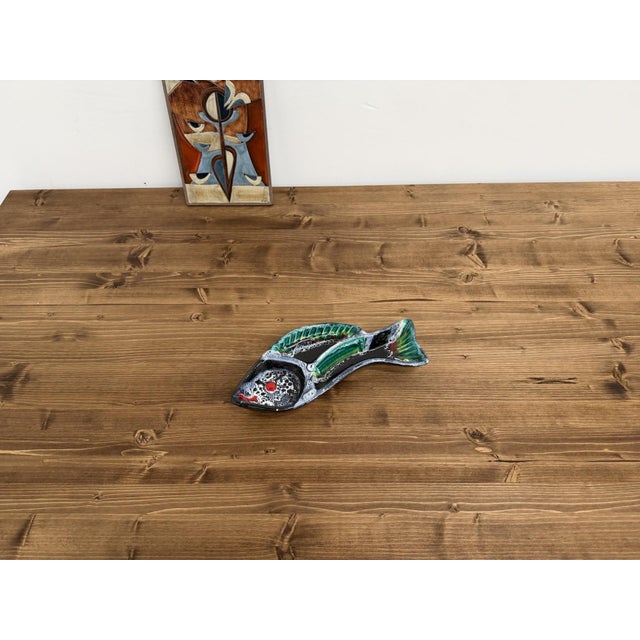 Mid-20th-century zoomorphic modernist ceramic piece, depicting a stylized fish with dynamic lines and pronounced relief....