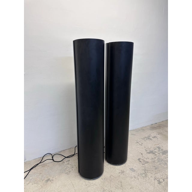 Pair of postmodern industrial black cylindrical torchiere floor lamps, circa 1990s. Lamps use a specialty 250w metal...