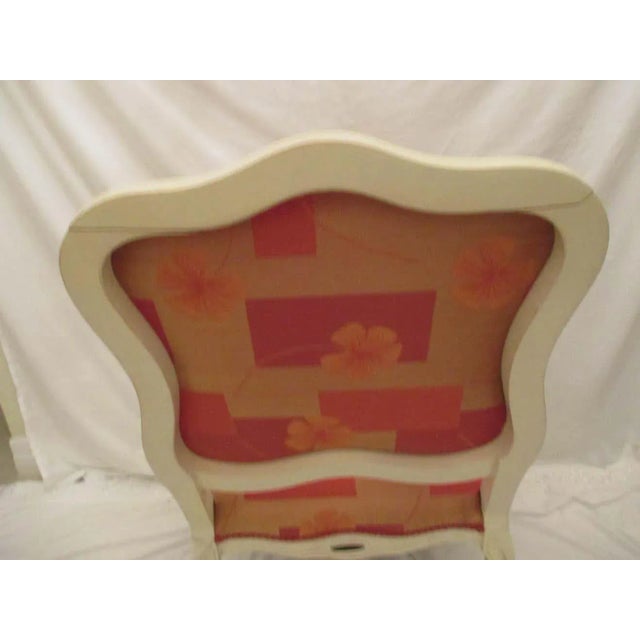 Bergere chair made in Italy with original orange floral upholstery in good condition. Chair has crack in top of the back...