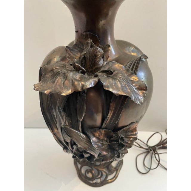 Amazing sculptural metal lamp of Iris and some flower buds coming up the side. Very much an art Noveau/Art Deco type vibe...