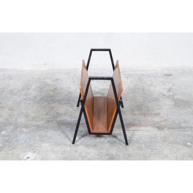 Nice magazine rack made of teak with an ebonized steel base, Made in Holland in the 60s
