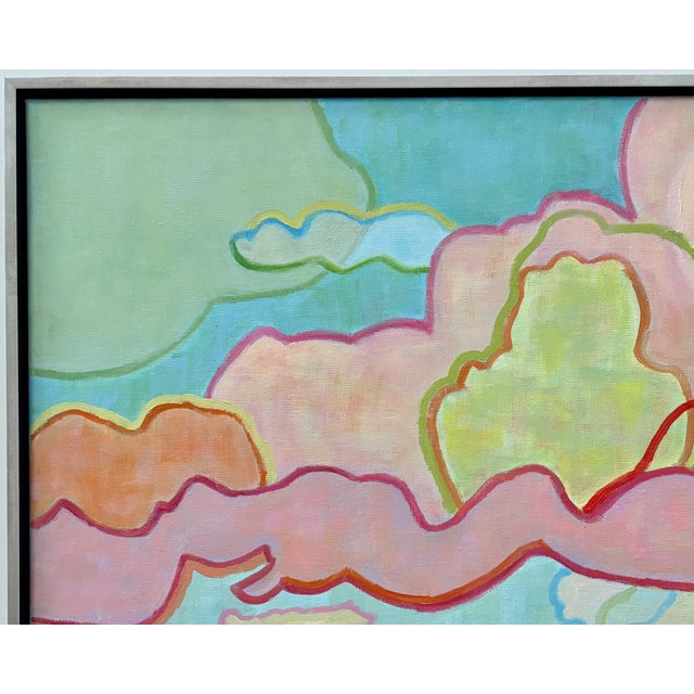 Abstract sky and landscape of colorful overlapping thunder clouds dancing above mountain peaks framed in a matte-silver...