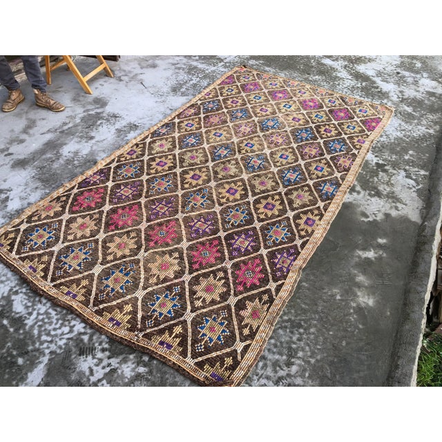 This is a vintage Turkish Anatolian kilim rug from the 1960s. The piece was hand-woven.