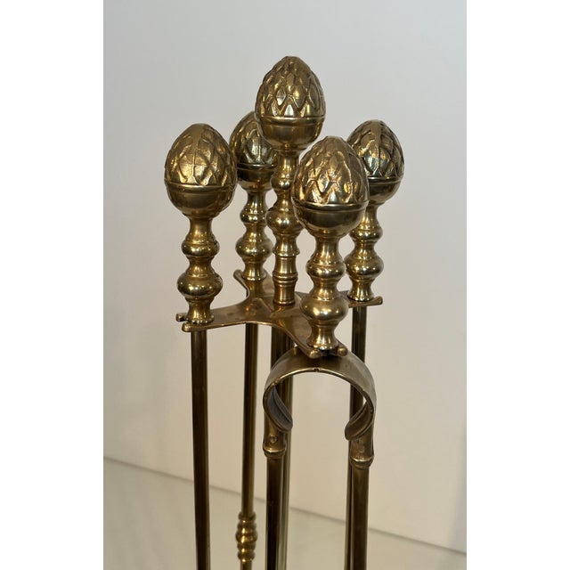 This very beautiful neoclassical style fireplace tool is made of brass. It is a French work in the style of Maison Baguès....