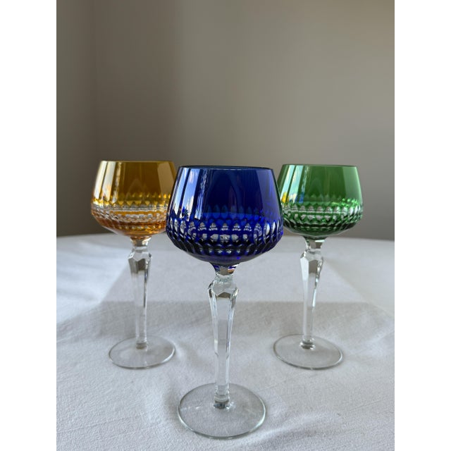 A set of six wine glasses made of coloured crystal glass with an elegant geometric cut. This piece is attributed to the...