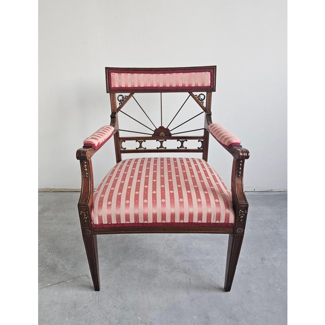 In this listing you will find a gorgeous French Empire style armchair done in mahogany and upholstered in striped fabric...