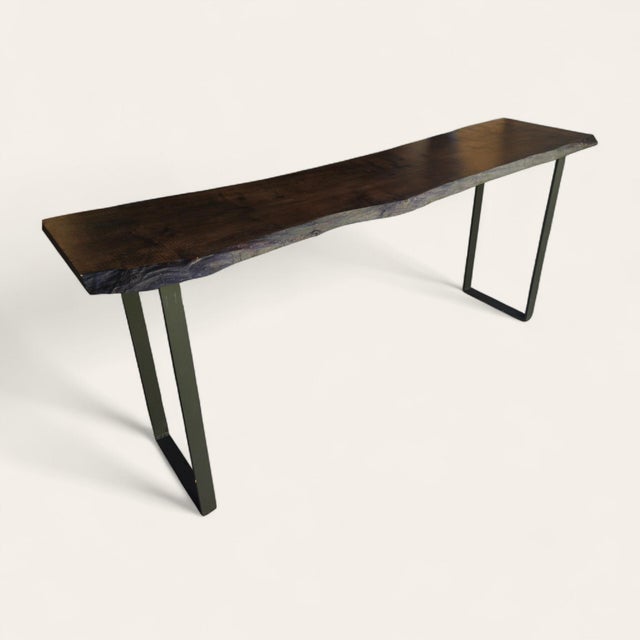 Large-scale spalted maple console table with a dark-finished slab top and symmetrical steel base. The maple was reclaimed...