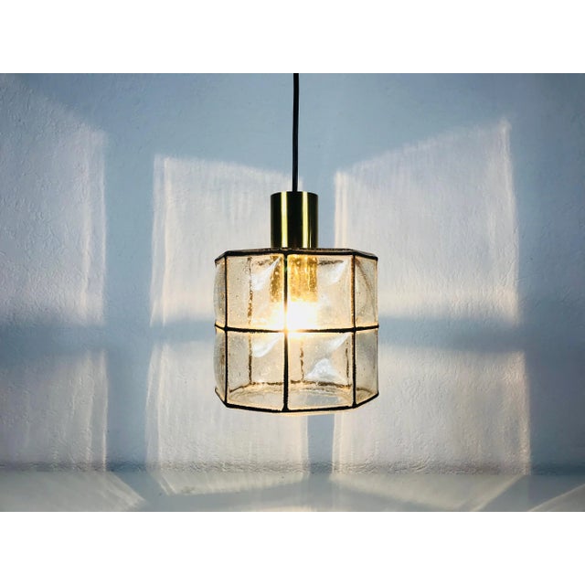 A Mid-Century Modern pendant lamp by Glashütte Limburg made in the 1960s in Germany. It is fascinating with its beautiful...