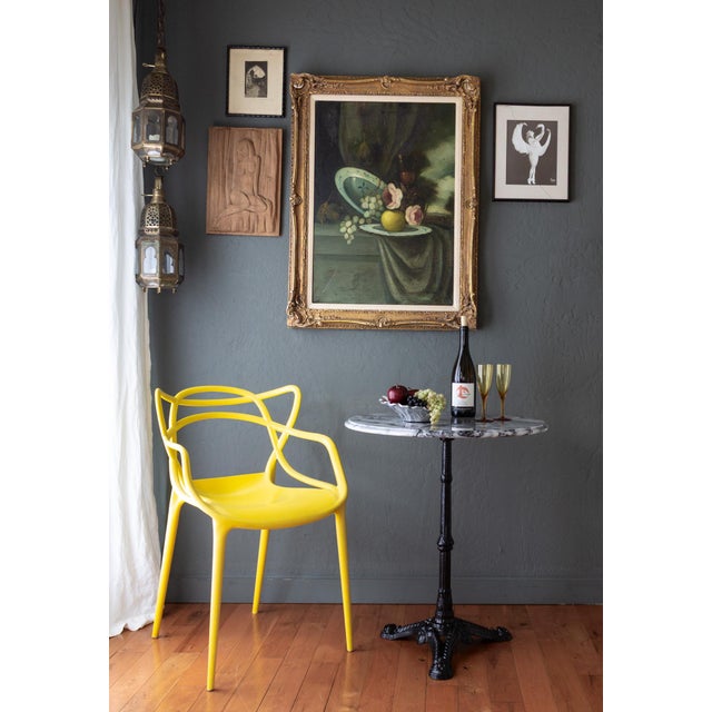 This beautifully preserved French bistro table features a white marble top with high-contrast black veining, an ogee edge,...