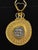 An AR Drachm Gorgoneion Pendant w/ Serpents in 22 Karat gold wide surround and blue diamond accent at top. This gorgoneion...