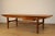 Elegant 1960s Scandinavian-style teak coffee table with clean, balanced lines typical of Nordic design. It is...