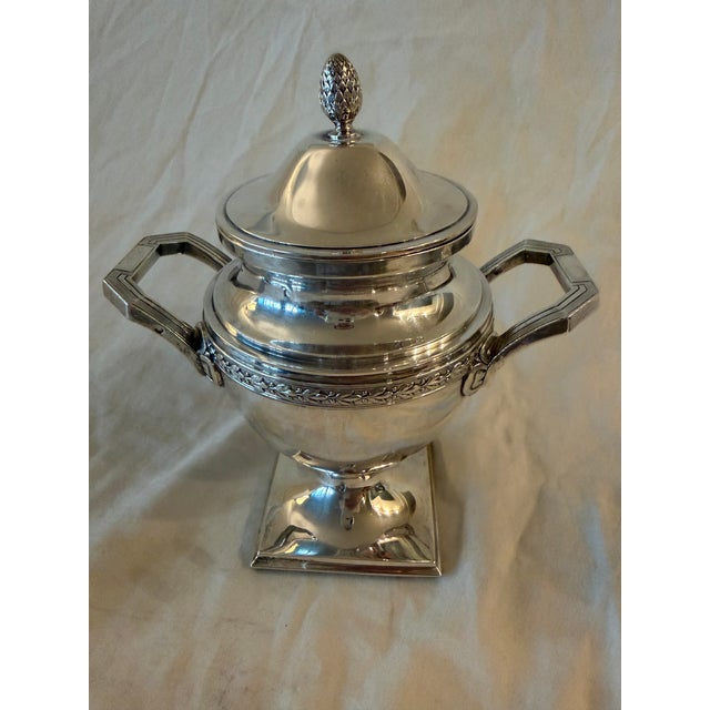 Late 19th century French sterling silver two-piece set consisting of a coffee/tea pot and a sugar bowl. The pieces reflect...