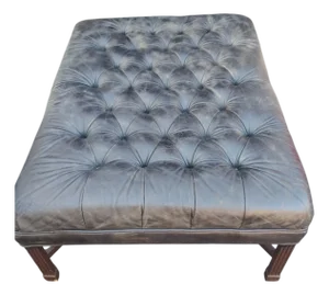 A Classic Leather Chesterfield Ottoman Ready to Add a Touch of Vintage Elegance to Your Home.