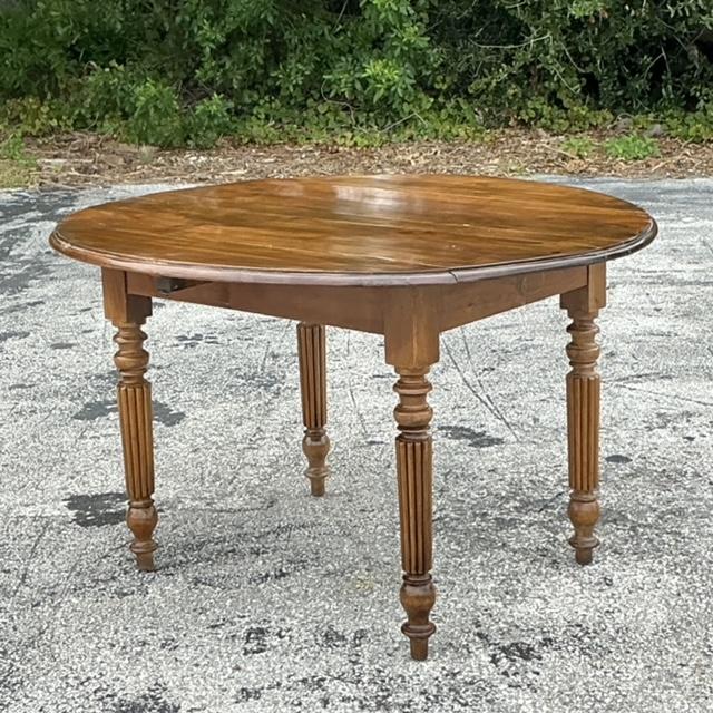 This vintage boho drop leaf dining table combines style and versatility. With its warm, natural wood tones and space-...