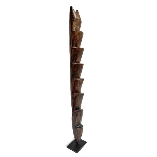 Vintage carved wood mini ladder from the Lega people of Democratic Republic of Congo. Displayed on black iron stand. Each...