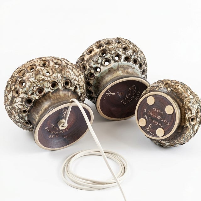 A set of three spherical stoneware pieces designed by Bruno Karlsson and produced at Ego Stengods Ateljé, Sweden, 1970s —...