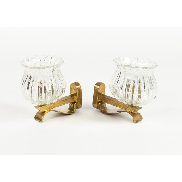 Midcentury beautiful pair of sconces in strong transparent thick Murano glasses with small air bubbles inside the glasses...