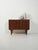 Danish cabinet from the 1950s–1960s, rosewood-effect laminate, hinged doors with recessed handles, and tapered legs. This...