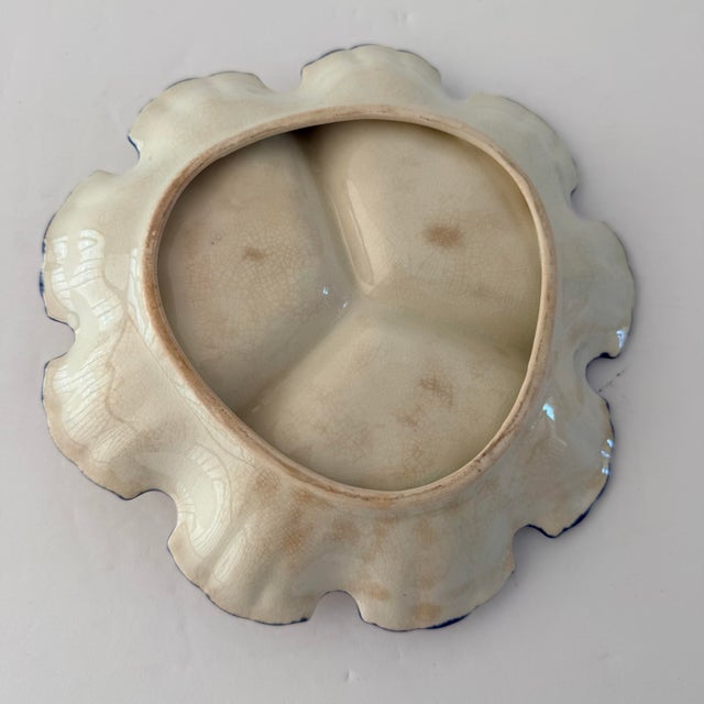 A charming vintage blue-and-white ceramic relish dish featuring three divided compartments, delicate floral decoration and...