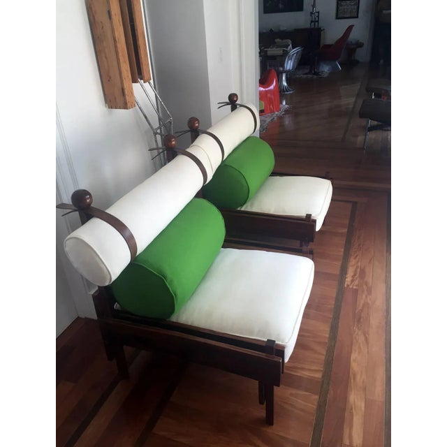 A pair of vintage rosewood lounge chairs designed by Sergio Rodrigues, made by Oca for Meia Pateca in Brazil, circa 1963....