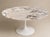 Circular dining table, "Tulip" model, created in 1957. Top in white Calacatta marble with beige and gray veining and a...
