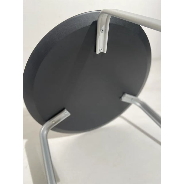 The legs are in painted extruded aluminium, the top is round in an embossed black finish. This piece is attributed to the...