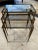 Lovely Mid-Century French Brass Nesting Tables With Smoke Glass. Features three size tables with simple decorative legs...