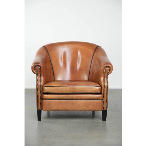 This beautiful, large, and spacious sheepskin club armchair has a unique size and is in good condition. It features...