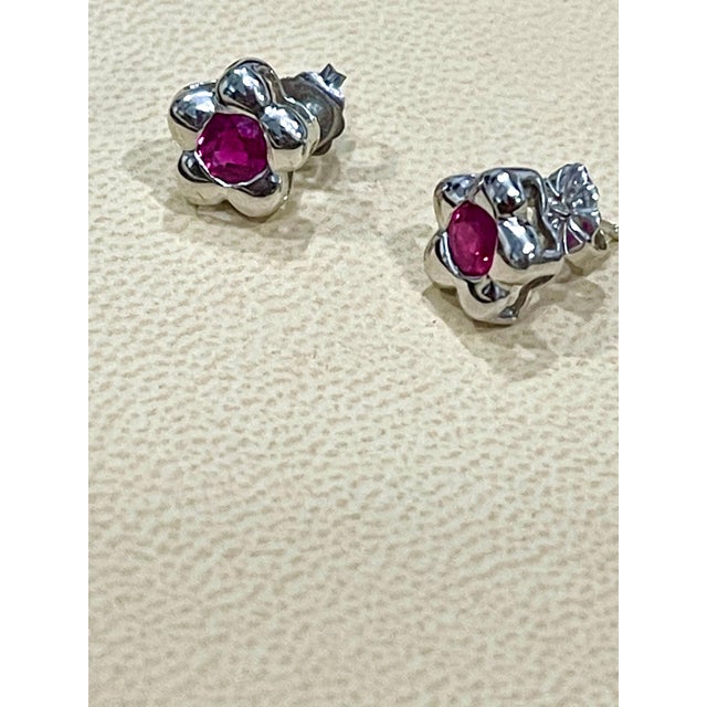 Approximately 1 Carat Natural Round Ruby Stud Earrings 14 Karat White Gold, Post Back This exquisite pair of earrings are...