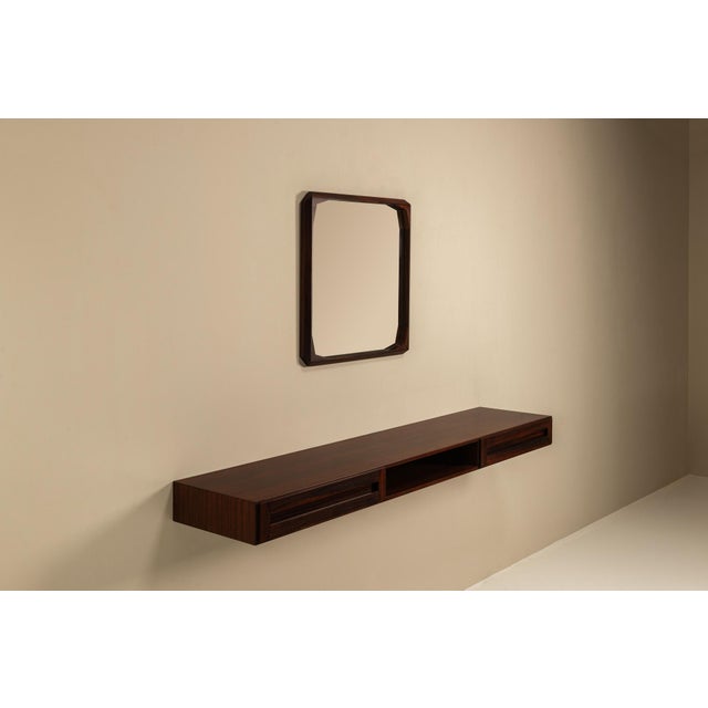 This wall-mounted console and mirror set, designed by Dino Cavalli for Tredici in the 1960s, captures the quiet elegance...