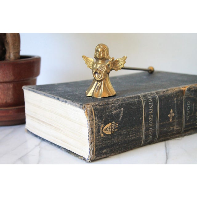 Vintage brass angel candle snuffer. No makers mark. Minor age wear.