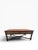 A richly crafted coffee table attributed to Theodore Alexander, likely from their well-regarded Armoury Collection (circa...