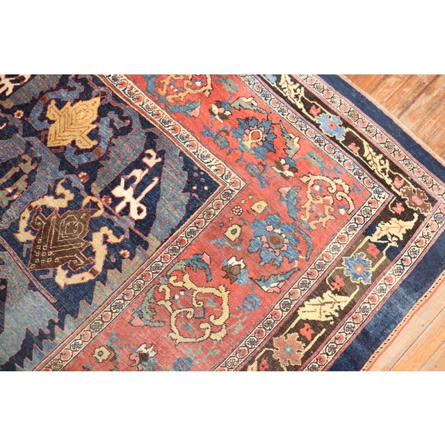 A late 19th-century large-size Persian Bidjar rug with an all-over spiral design on a navy field. Measures: 12' x 18'2''.