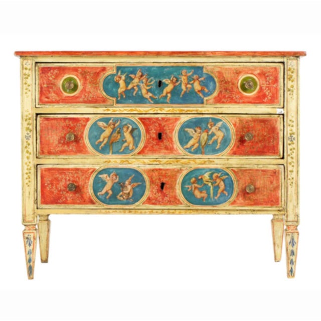 A vibrant and highly decorative Italian commode originating from the 19th century. This piece captures the theatrical...