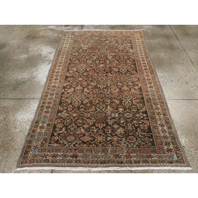 This mid-20th-century Persian Malayer accent rug presents a richly detailed allover composition across a deep brown field....