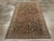 This mid-20th-century Persian Malayer accent rug presents a richly detailed allover composition across a deep brown field....